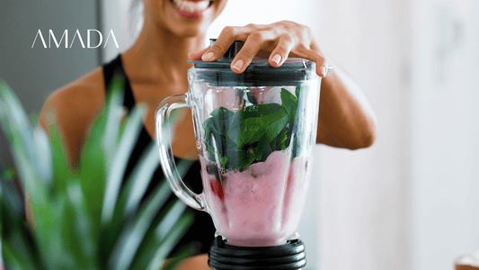 A woman is blending her delicious smoothie after a yoga session.